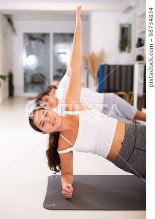 Young woman practicing pilates in gym room Young woman practicing pilates in gym room 98734834