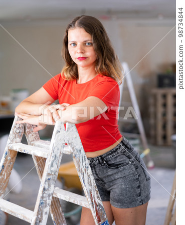 Young seductive woman posing in apartment during repair works Young seductive woman posing in apartment during repair works 98734844