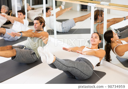 Young woman practicing pilates in gym room Young woman practicing pilates in gym room 98734959