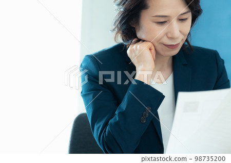 Personnel officer looking at application documents Personnel officer looking at application documents 98735200