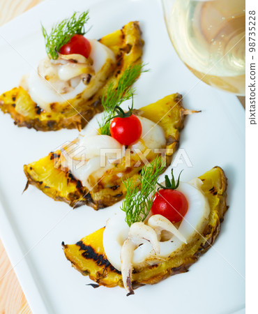 Grilled sepia and pineapple with cherry tomatoes and sweet-sour sauce chile Grilled sepia and pineapple with cherry tomatoes and sweet-sour sauce chile 98735228