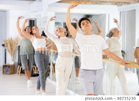 Group of different people doing ballet at barre Group of different people doing ballet at barre 98735230