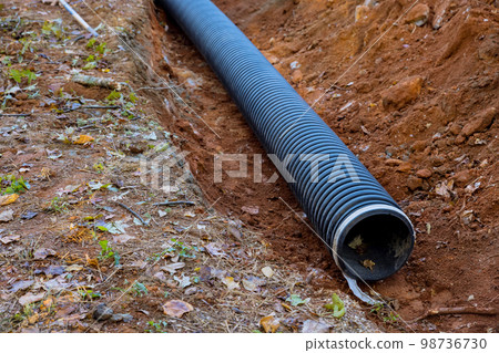 Laying for underground installation of PVC sewage black pipes in ground is prevent subterranean flooding. Laying for underground installation of PVC sewage black pipes in ground is prevent subterranean flooding. 98736730
