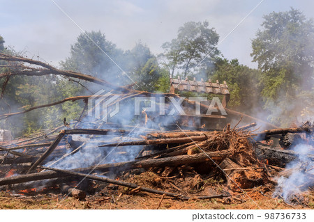 During construction of house uprooted forest was burned for construction of house to help build structure During construction of house uprooted forest was burned for construction of house to help build structure 98736733