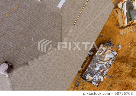 Roof of house had new shingles installed by construction roofing worker 98736768