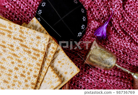 During Jewish holiday of Pesach, kosher kiddush wine unleavened bread matzah is Passover celebration During Jewish holiday of Pesach, kosher kiddush wine unleavened bread matzah is Passover celebration 98736769