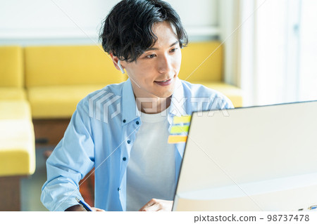 Young man working remotely Young man working remotely 98737478