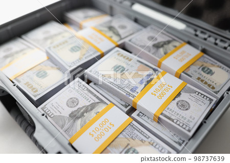 Close-up of briefcase full of stacks of dollar bills. Metal suitcase full of money. Close-up of briefcase full of stacks of dollar bills. Metal suitcase full of money. 98737639