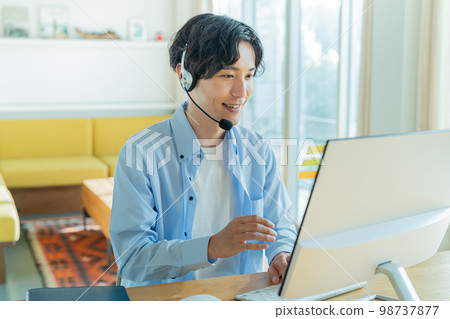 Young man working remotely Young man working remotely 98737877