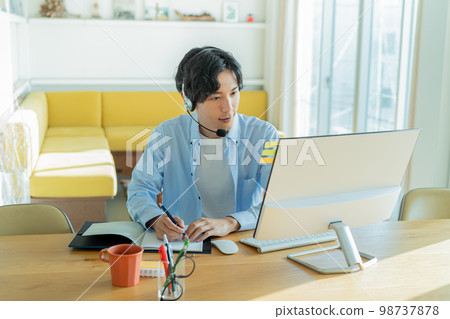 Young man working remotely Young man working remotely 98737878