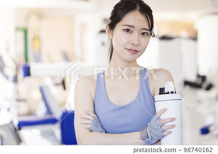 Young woman with protein bottle at sport gym Young woman with protein bottle at sport gym 98740162