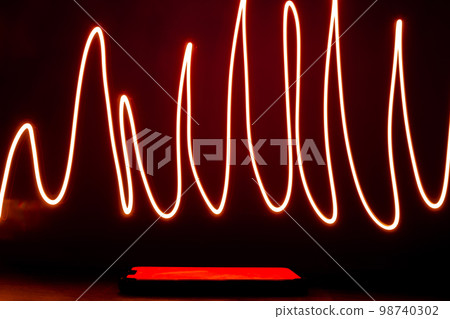 Abstract red lines drew by using long exposure of camera and flash light shape of graphic. Investing in the online puppet market. Network internet mobile wireless Abstract red lines drew by using long exposure of camera and flash light shape of graphic. Investing in the online puppet market. Network internet mobile wireless 98740302