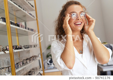 Eyeglasses Store. Woman with Glasses For Eyesight Correction Eyeglasses Store. Woman with Glasses For Eyesight Correction 98741176