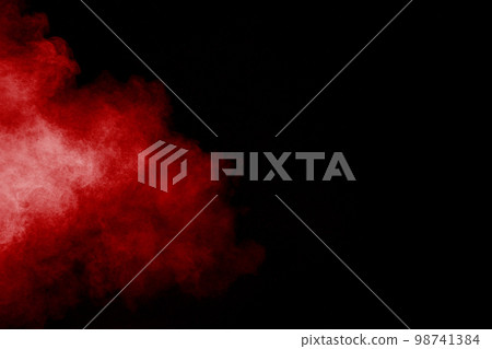 Red powder explosion cloud on black background. Freeze motion of red color dust particles splashing. Red powder explosion cloud on black background. Freeze motion of red color dust particles splashing. 98741384