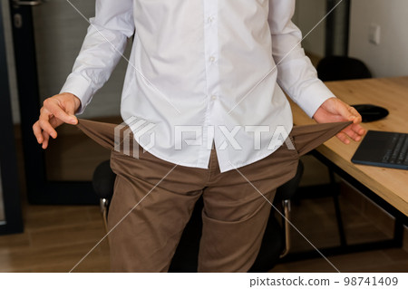 Empty pockets. Disappointed businessman with empty pockets. Empty pockets. Disappointed businessman with empty pockets. 98741409