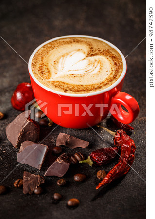 Coffee cup with chili peppers and chocolate 98742390