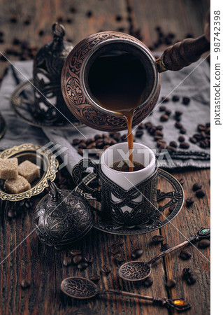 Pouring turkish coffee Pouring turkish coffee 98742398
