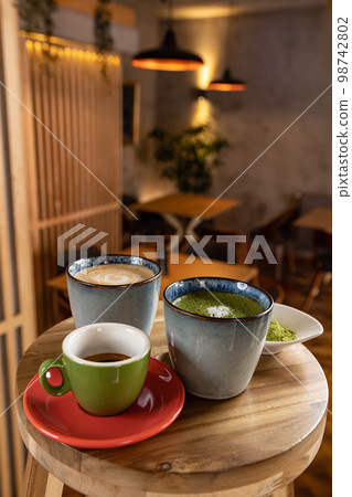 Cups of coffee, espresso and matcha latte 98742802