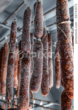 Dried-up salami hanged up 98743072