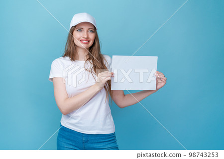 Beautiful young woman holding blank white paper board, your text here concept Beautiful young woman holding blank white paper board, your text here concept 98743253