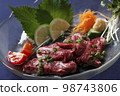 Platter photo of fresh beef sashimi served with vegetables 98743806