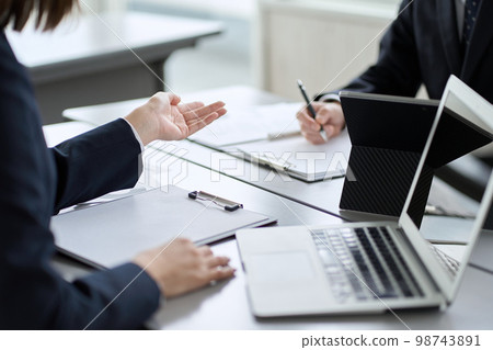 Hands of an Asian business person having a meeting in a conference room 98743891