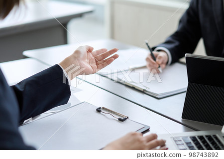 Hands of an Asian business person having a meeting in a conference room 98743892