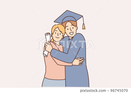 A young graduate in a cap with a diploma next to his mother A young graduate in a cap with a diploma next to his mother 98745070