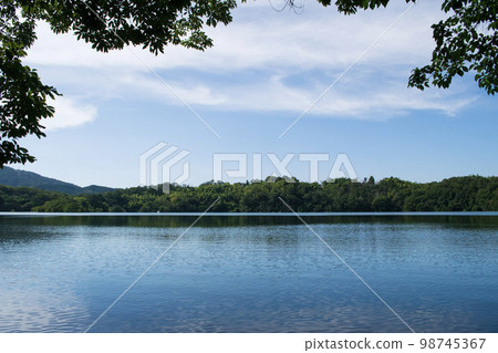 Lake Ippeki in Ito City where the blue sky and green trees are reflected Lake Ippeki in Ito City where the blue sky and green trees are reflected 98745367