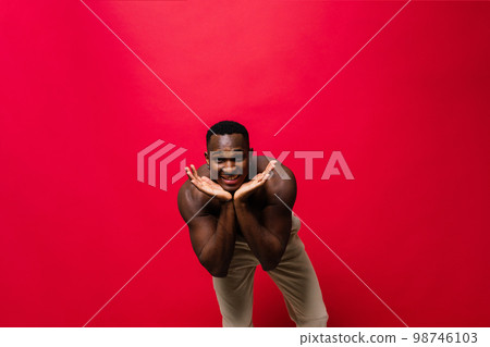 Like what you see. A handsome and muscular young man posing in the studio. Like what you see. A handsome and muscular young man posing in the studio. 98746103