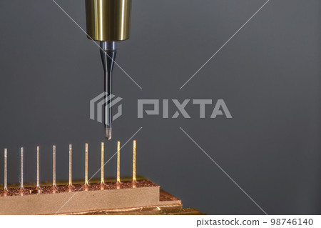 Close up scene the CNC milling machine cutting the copper electrode parts with solid ball end mill. 98746140