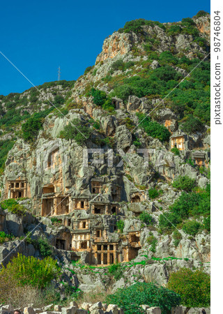 Ruins of Rock-cut tombs in ancient Lycian city of Myra. Lycian way, Demre, Antalya province, Turkey. 98746804