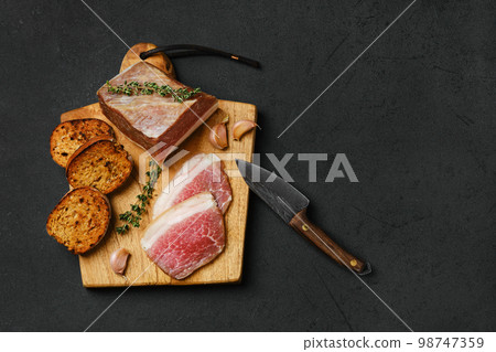 Top view of salted pork belly joint meat on wooden cutting board 98747359