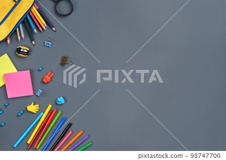 Flat lay photo of workspace desk with school accessories or office supplies. 98747700