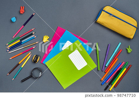 Flat lay photo of workspace desk with school accessories or office supplies. 98747710