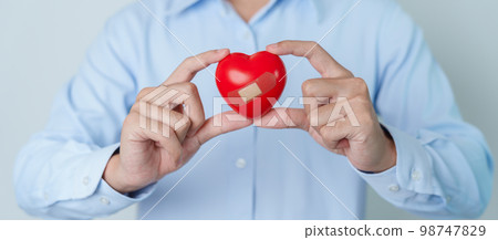 man hand holding red heart shape. love, donor, world heart day, world health day and Insurance concepts 98747829