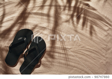 Traveler vacation accessories are laid out on a white beach sand. Flat lay, top view. 98747860