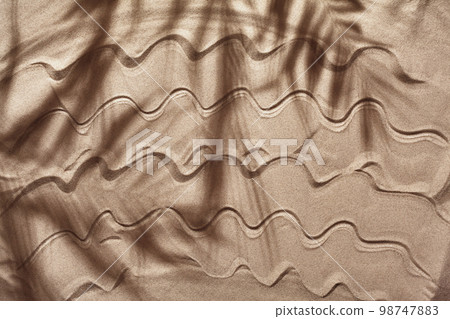 Summer concept with a shadow of a tropical palm tree leaves, copyspace on a white beach sand. 98747883