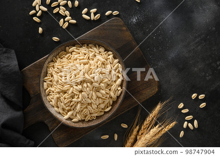 Dry homemade pasta Cavatelli in plate on black. 98747904