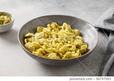 Pasta Cavatelli with sauce pesto on gray background. Pasta Cavatelli with sauce pesto on gray background. 98747905