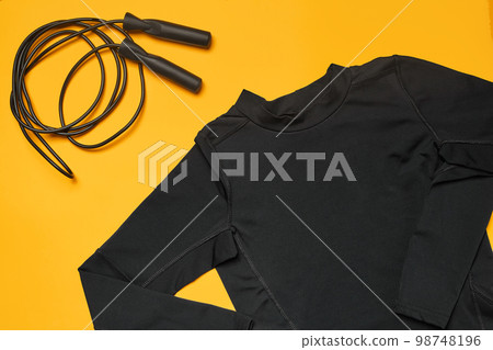 Close-up studio shot of a gym accessories on a yellow background. Top view, flat lay. Close-up studio shot of a gym accessories on a yellow background. Top view, flat lay. 98748196