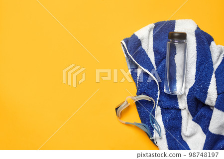 Flat lay summer pool accessories on a yellow background. Colorful beach wear. Flat lay summer pool accessories on a yellow background. Colorful beach wear. 98748197