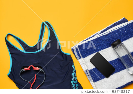 Flat lay summer pool accessories on a yellow background. Colorful beach wear. Flat lay summer pool accessories on a yellow background. Colorful beach wear. 98748217