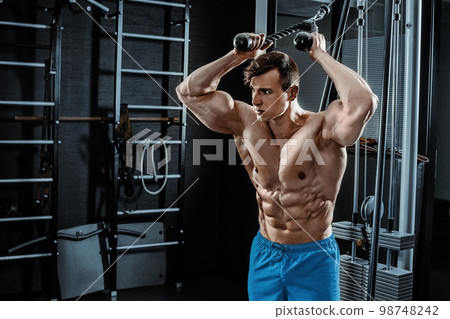 Sexy muscular man posing in gym, shaped abdominal. Strong male naked torso abs, working out Sexy muscular man posing in gym, shaped abdominal. Strong male naked torso abs, working out 98748242