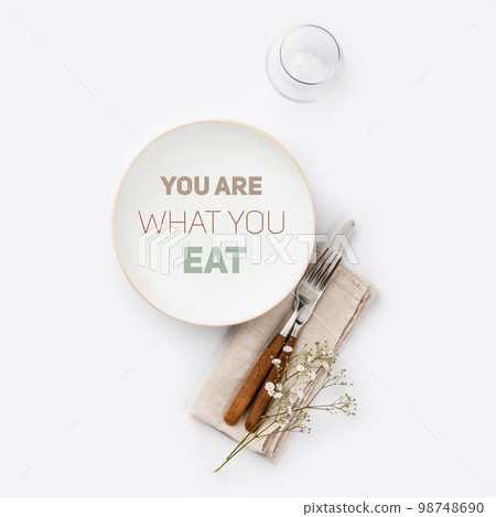 Quote You are what you eat on white plate with cutlery and napkin 98748690