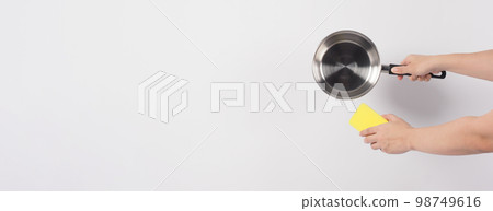 Pot cleaning Man hand on white background cleaning the non stick pot with handy dish washing sponge which yellow color on the soft side and green on hard side for hygiene after cook. Electric pot Pot cleaning Man hand on white background cleaning the non stick pot with handy dish washing sponge which yellow color on the soft side and green on hard side for hygiene after cook. Electric pot 98749616