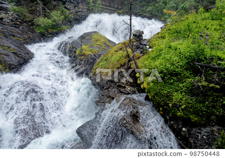 Travel destination Norway - Waterfall - Jostedalsbreen National Park Travel destination Norway - Waterfall - Jostedalsbreen National Park 98750448
