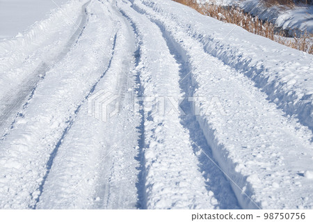 Road rut on a snowy day Road rut on a snowy day 98750756