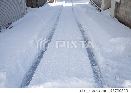 Snow ruts in a residential area Snow ruts in a residential area 98750823