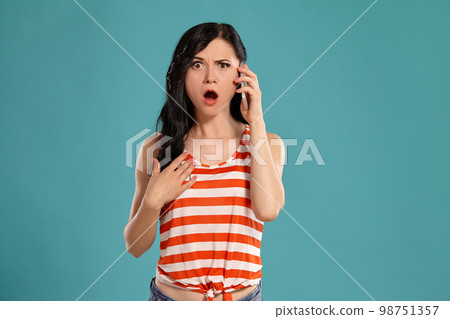 Studio photo of a gorgeous girl teenager posing over a blue background. Studio photo of a gorgeous girl teenager posing over a blue background. 98751357